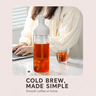 White 800ml cold brew bottle with coffee beside a home workspace