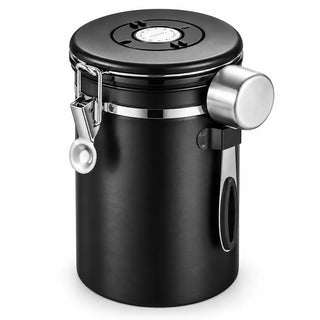 Black airtight stainless steel coffee canister with date dial, metal latch and measuring scoop on a white background
