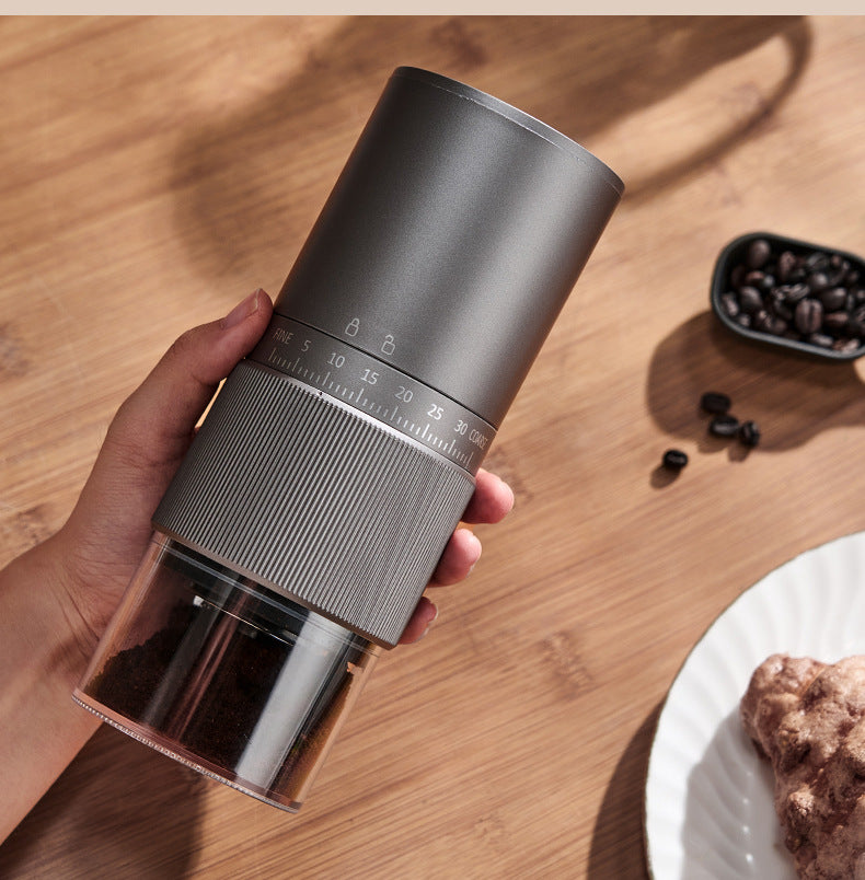 Yozcoffee gray automatic espresso grinder with adjustable grind size on wooden coffee table
