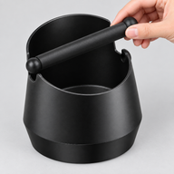 Removable black silicone knock bar lifted from the Large espresso knock box