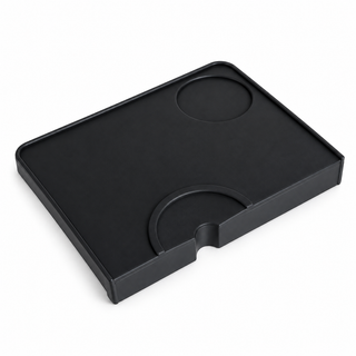 Yozcoffee black silicone espresso tamping mat on a white background, showing the front portafilter rest and rear circular recess