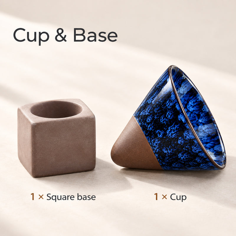 One conical ceramic coffee cup and one separate square ceramic base