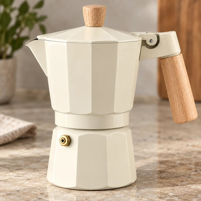 Cream moka pot showing wood-look handle and brass-colored safety valve