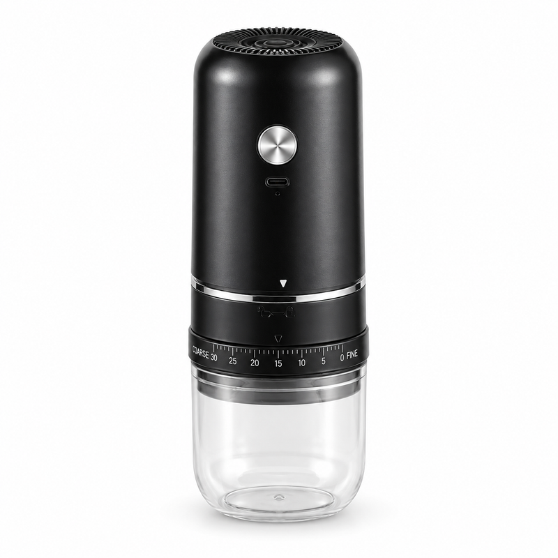 Black Yozcoffee electric coffee grinder with silver button and clear grounds cup on a white background