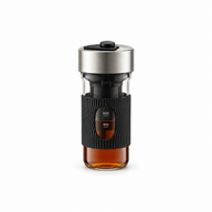 600 mL electric cold brew coffee maker with a silver lid, black grip sleeve and glass body on a white background