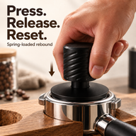 Black espresso tamper being pressed vertically into a supported portafilter
