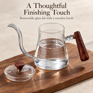 Glass gooseneck kettle with its removable glass lid and wooden knob placed alongside
