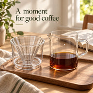 Yozcoffee glass dripper and 400 ml coffee server on a wooden tray beside a book