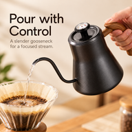 Curved gooseneck spout of the black kettle directing water into a pour-over filter