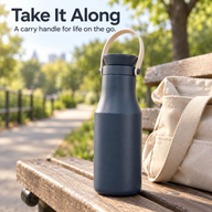 Navy insulated bottle with carry handle on a park bench beside a bag