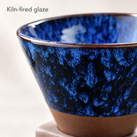 Close-up of the blue and black kiln-glazed ceramic coffee cup finish