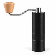 Black Yozcoffee manual coffee grinder with textured center grip band and wood-knob crank on white