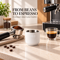 Matte white coffee weighing cup beside a portafilter and espresso