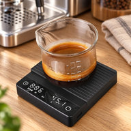 Black Yozcoffee mini coffee scale weighing espresso on a wooden home coffee bar