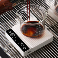 Ivory mini coffee scale weighing espresso on a drip tray