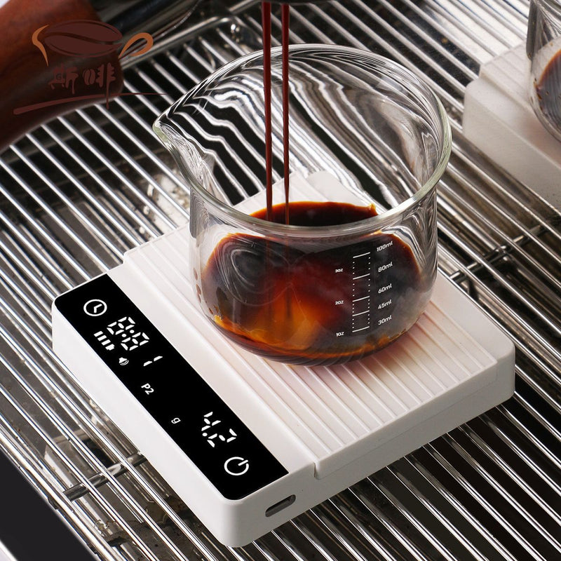 Ivory mini coffee scale weighing espresso on a drip tray