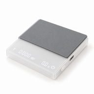 White digital coffee scale with gray silicone pad on a white background