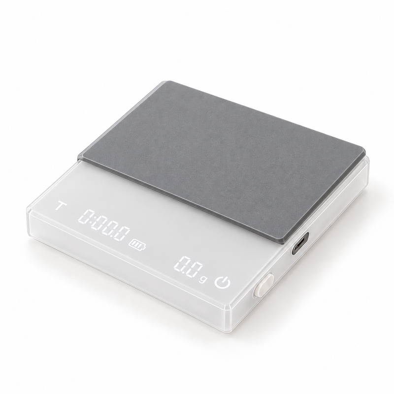 White digital coffee scale with gray silicone pad on a white background