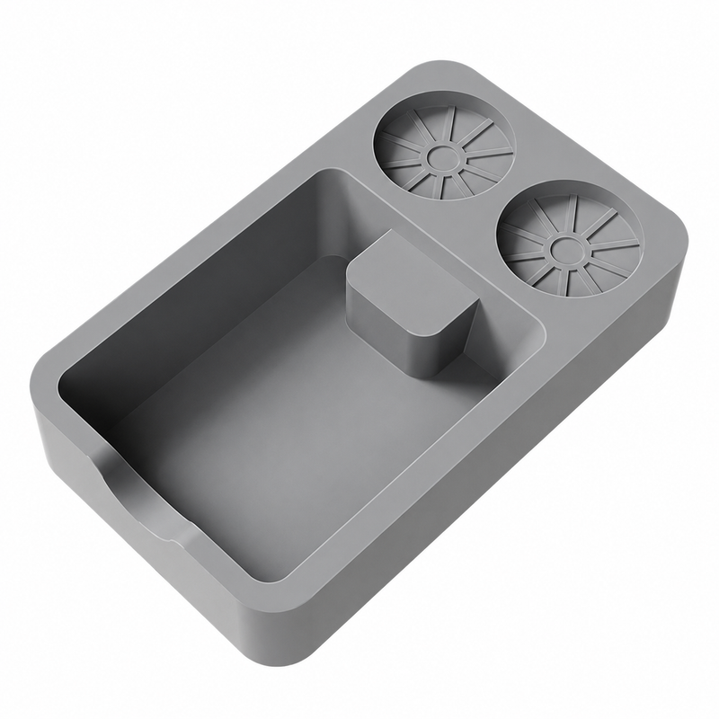 Overhead view of the gray silicone tamping mat with a deep tray, center rest, and two round tool holders