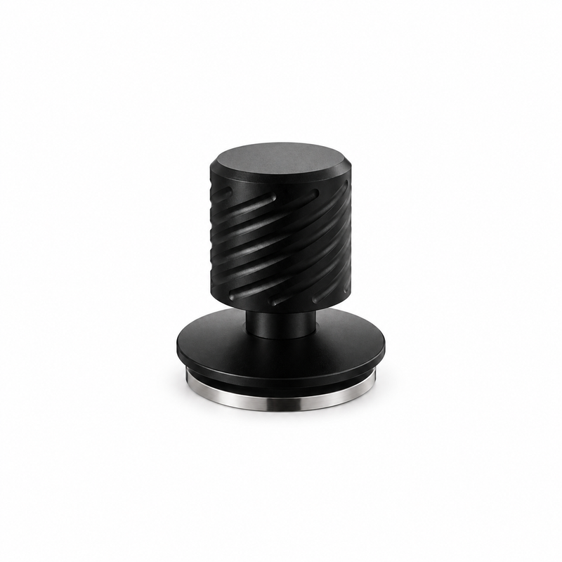 Yozcoffee matte black spring-loaded espresso tamper on white with grooved handle and silver stainless steel base