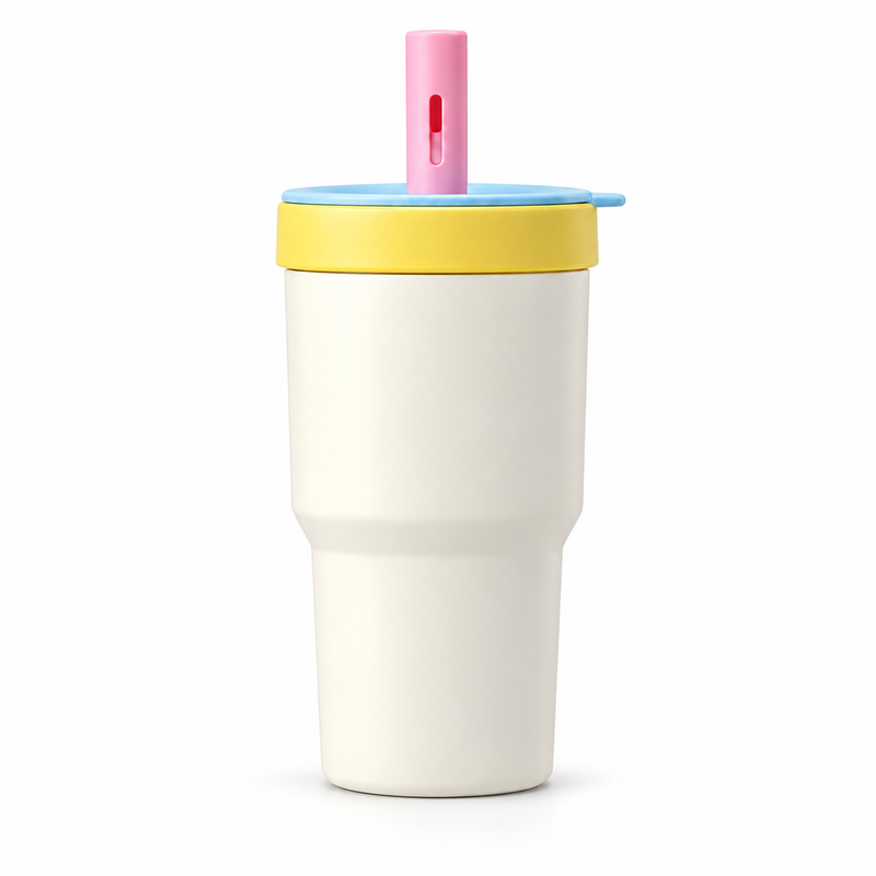 Cream and yellow straw tumbler with blue lid and pink cap on white background