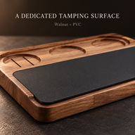 Close-up of black PVC tamping pad and rounded walnut edge