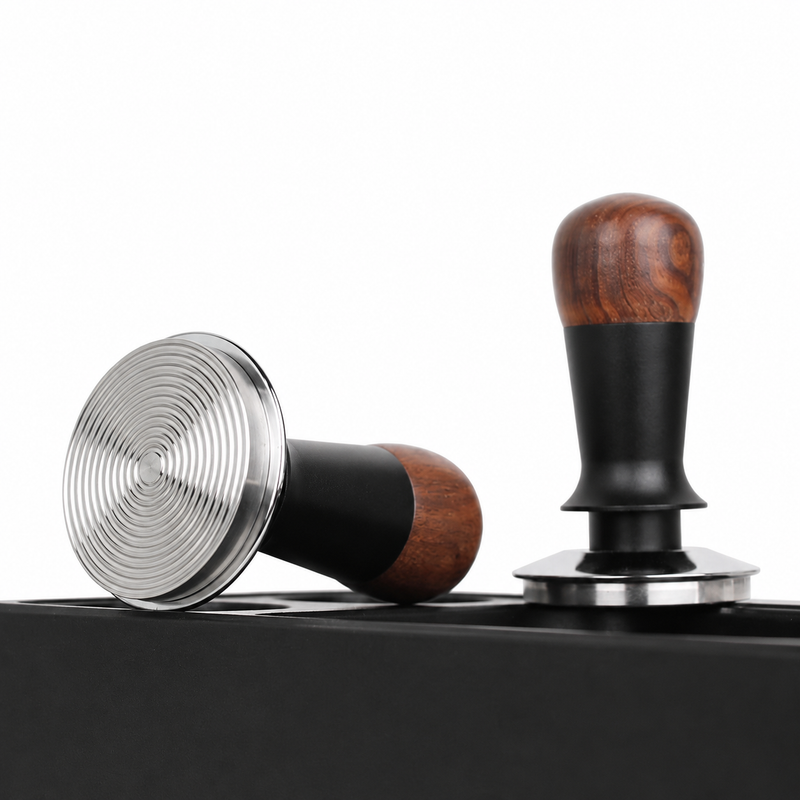 Two angles of the Yozcoffee walnut wood constant force espresso tamper on an espresso station