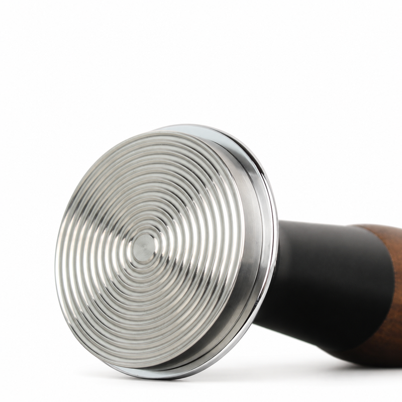Close-up of the ripple-pattern base on the Yozcoffee walnut wood espresso tamper